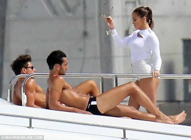 White hot woman: Jennifer Lopez shows off her perfect figure to two nearly naked models during a World Cup video shoot in Miami, Florida on Wednesday