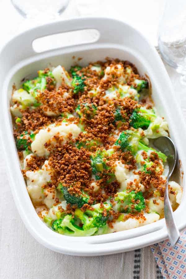 broccoli and cauliflower casserole in baking dish with spoon
