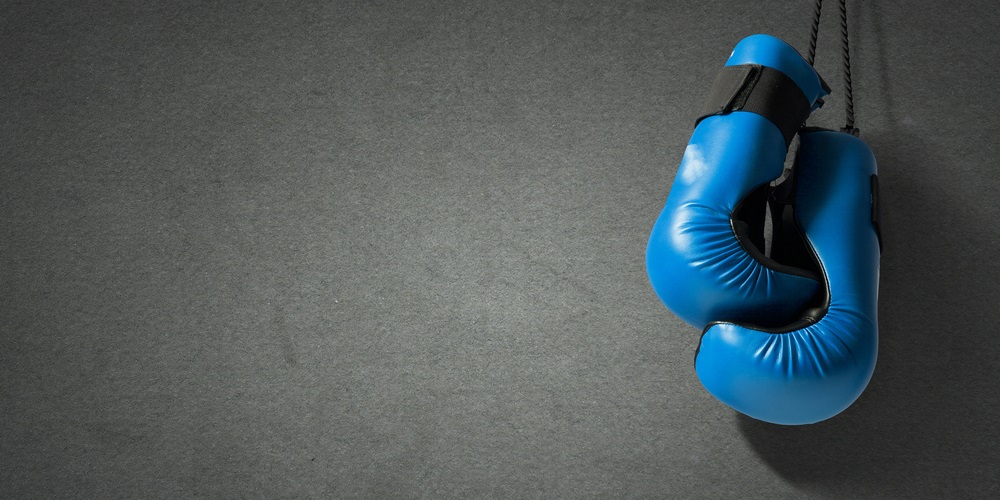 Blue boxing gloves on a black background